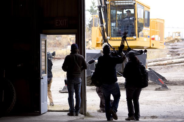 Carrying a tripod out of the logging mill